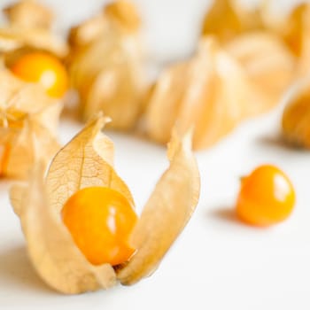 ripe healthy orange physalis over wooden board