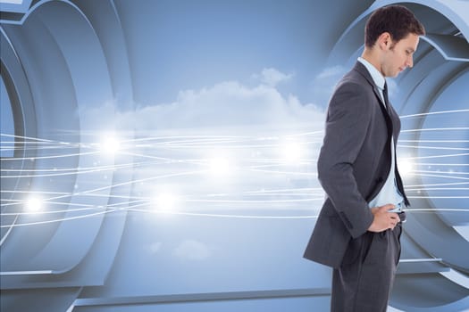 Serious businessman with hands on hips against abstract white cloud design