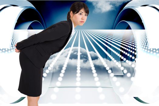 Serious businesswoman bending against abstract design in blue and white