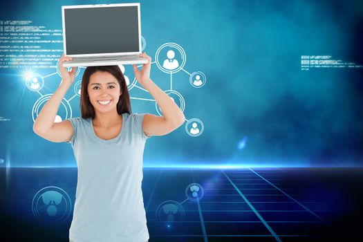 Gorgeous woman posing with her laptop against futuristic technology interface