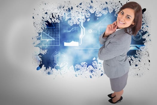Smiling thoughtful businesswoman against splash on wall revealing technology interface