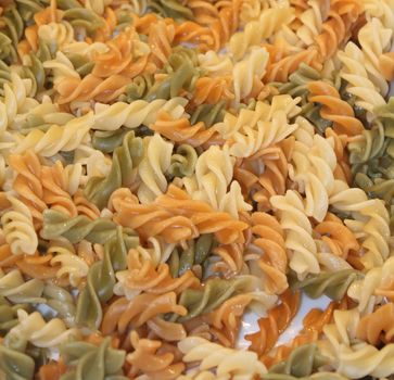 Italian Fusilli or Rotini helix shaped Macaroni Pasta raw food background or texture close up