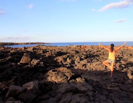 woman practice yoga at sunrise seaside