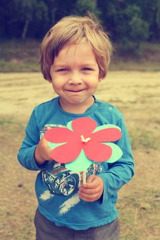 Handsome smiling boy on a background of nature on