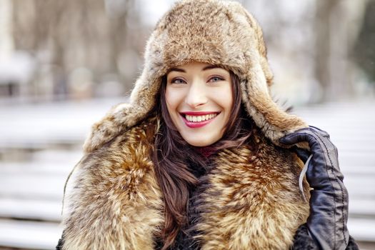 Woman in cold weather wearing real fur fashion clothes