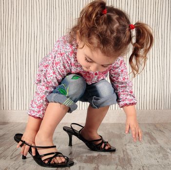 a little girl with mom shoes