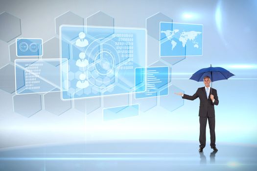 Peaceful businessman holding blue umbrella against futuristic technology interface