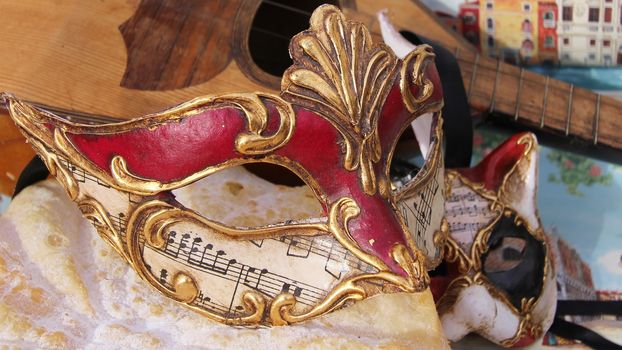 Baroque mask with cat mask and a mandoline.