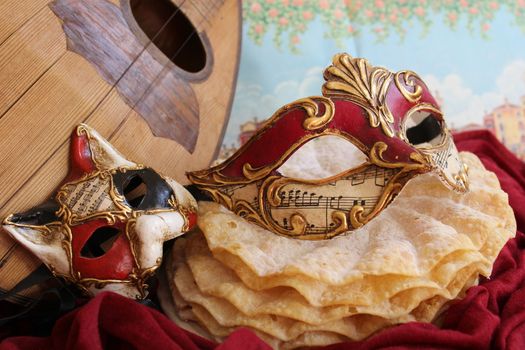 Baroque carnival mask with cat mask and pancakes , and a mandolin