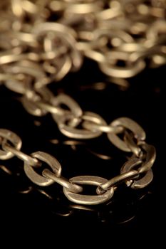 detail of a gold chain on a black background