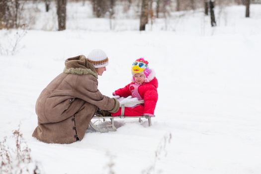child with mother in winter outdoors