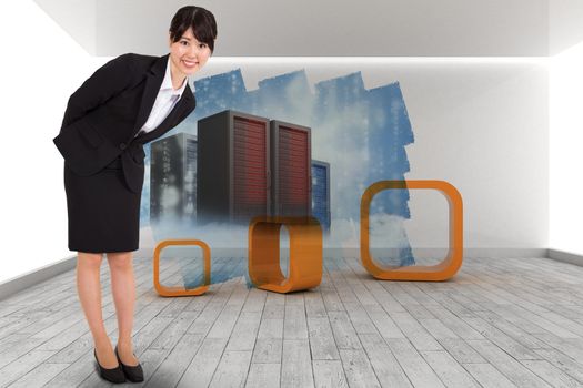 Smiling businesswoman bending against abstract screen in room showing server towers