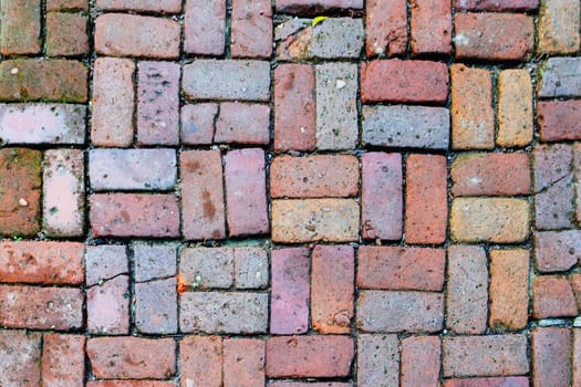 Brick path with different colors stones.