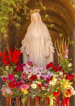 Virgin Mary Statue Flowers Garden Mission San Buenaventura Ventura California.  Founded 1782 by  Father Junipero Serra.  Named for Saint Bonaventure