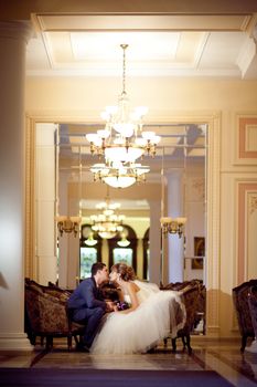 bride and groom in golden hall