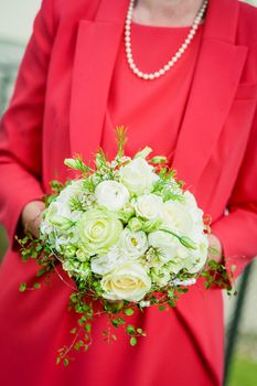 Bride with red dress holding wedding bouquet