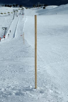 Wooden bollard nearby slope in Austria nearby Kaltenbach in Zillertal valley