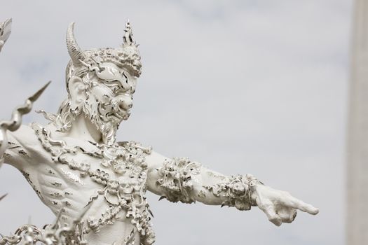 white sculpture of giant in Thai temple.