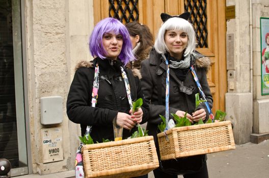 French girls selling flowers on Labor Day, Paris.
