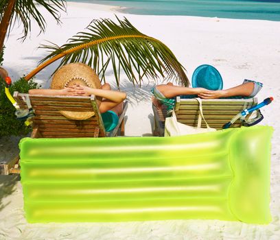 Couple in green on a tropical beach at Maldives