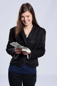 Young long-haired woman holding fan-shaped dollars in his hand