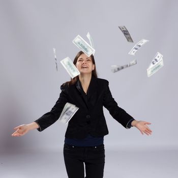 Young long-haired woman throws dollars up to