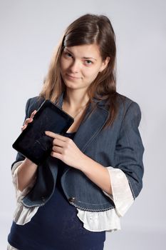 Young long-haired woman with glasses sad, holding in his hands broken tablet pc