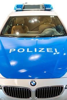 MUNICH, GERMANY - DECEMBER 27, 2013: Closeup front view of new modern German police car, announced in BMW Welt show. Isolated on white.