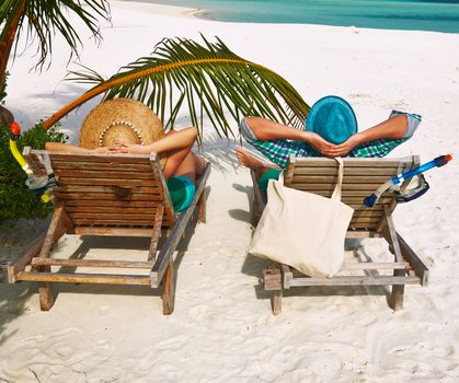 Couple in green on a tropical beach at Maldives