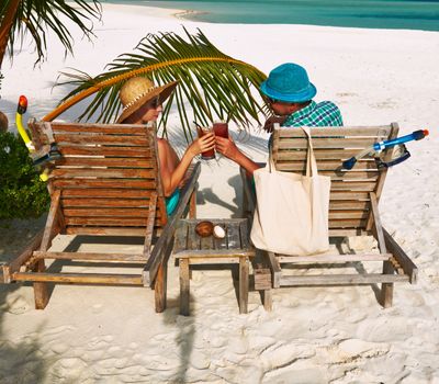 Couple in green on a tropical beach at Maldives