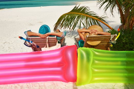 Couple in green on a tropical beach at Maldives