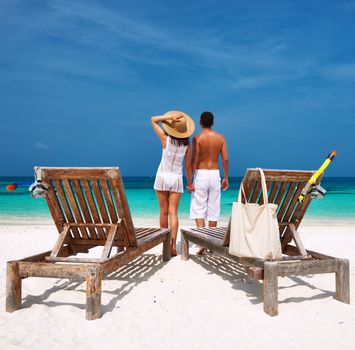 Couple in white on a tropical beach at Maldives