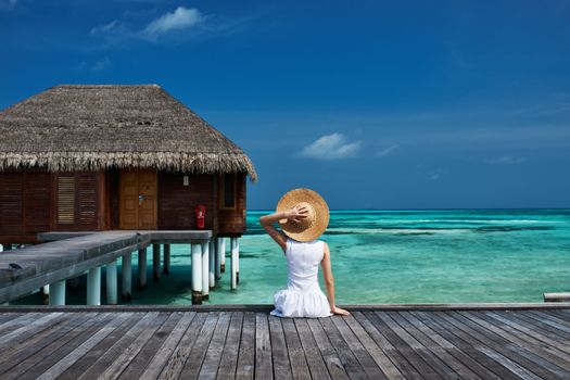 Woman on a tropical beach jetty at Maldives