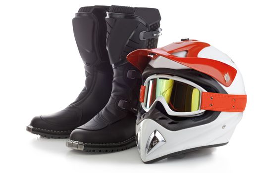 Motocross boots and protective helmet for motorcycle riding isolated on white