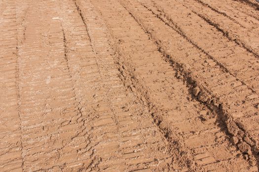 Wheel tracks on the soil as backhoe service