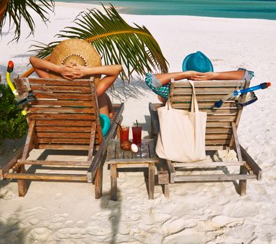 Couple in green on a tropical beach at Maldives