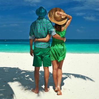 Couple in green on a tropical beach at Maldives