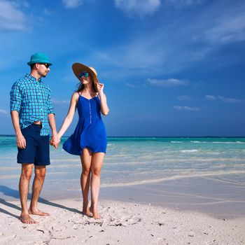 Couple in blue on a tropical beach at Maldives