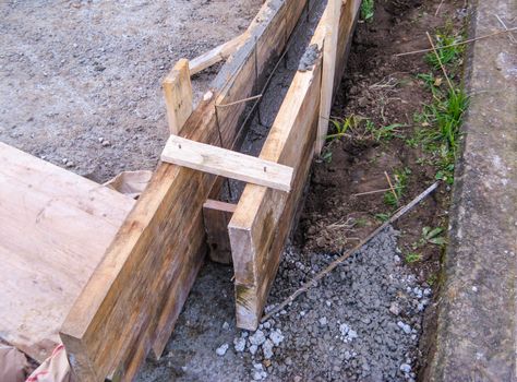 Concrete formwork with wooden planks in the construction process