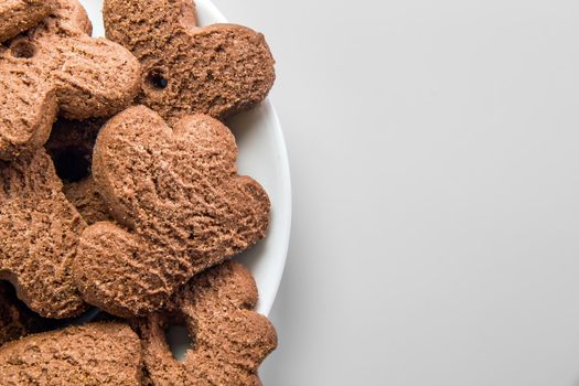 Several chocolate cookies over white dish