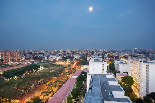 Full Moon Over Singapore Housing Estate by MRT Train Station at Blue Hour