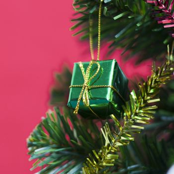 close up green gift christmas on red background