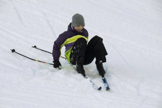 A young boy having fun on ski