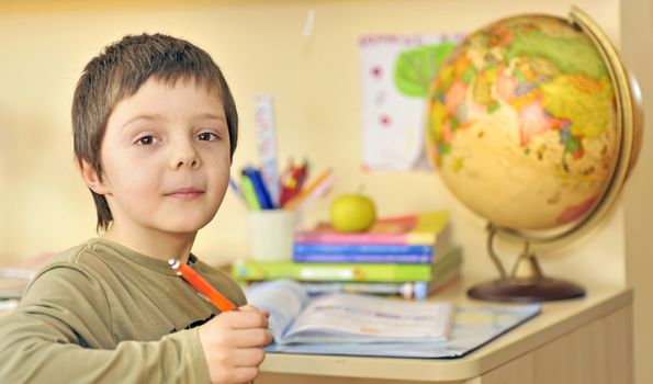 boy  doing homework in his room