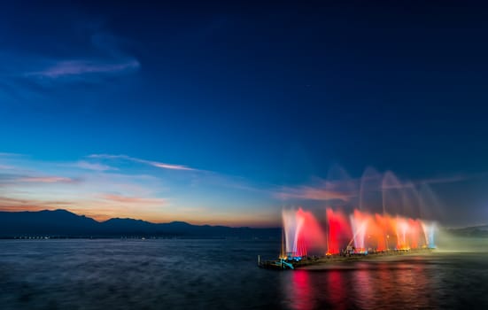 colorful of fountain on water in twilight time with motion blur effect