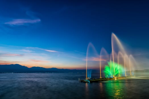 colorful of fountain on water in twilight time with motion blur effect