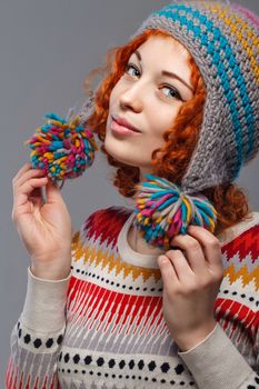 Attractive young red-haired girl in a warm knitted hat