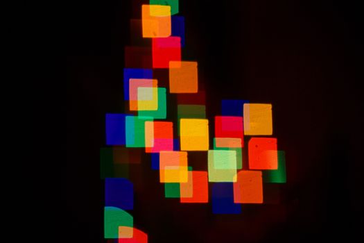 Abstract bokeh background in the form of squares on the night street