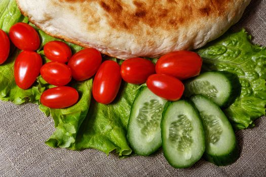 Traditionally pita with lettuce and fresh tomatoes with cucumbers shot closeup