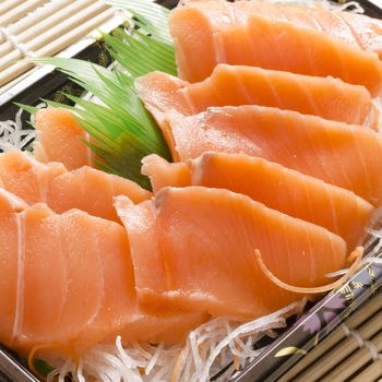 fresh salmon piece for sushi on wood background